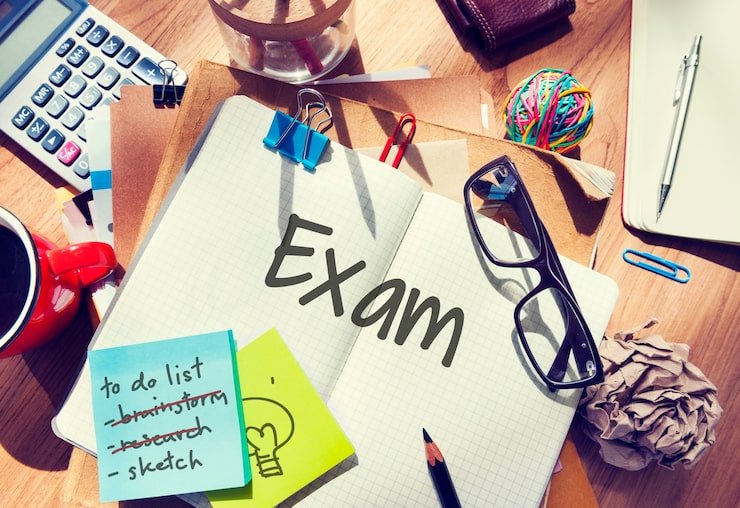 A picture showing an open copy and exam written in it